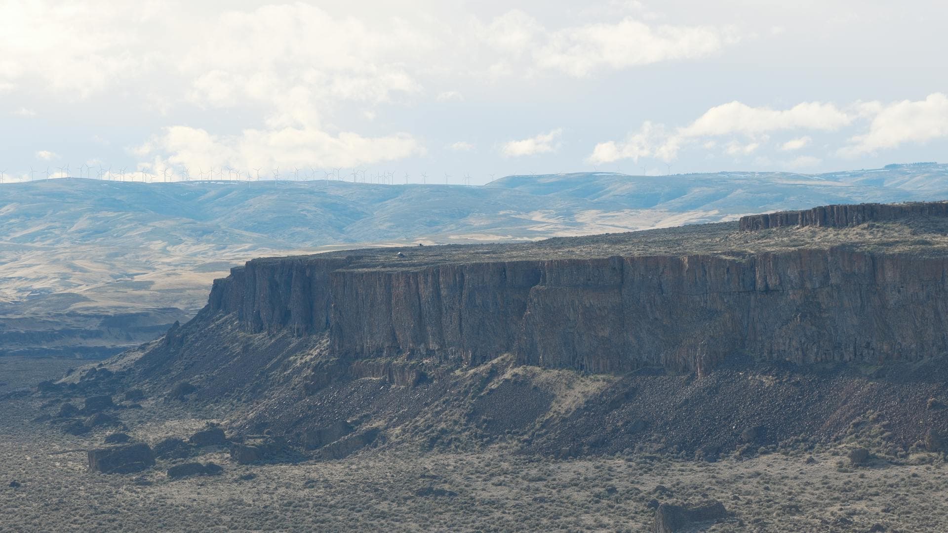 Dramatic basalt cliffs of the Columbia Basin in eastern Washington with arid high desert landscape stretching to the horizon