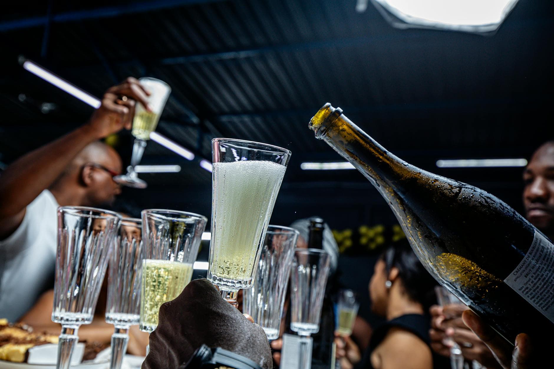 Friends raising champagne glasses in a toast at an intimate gathering
