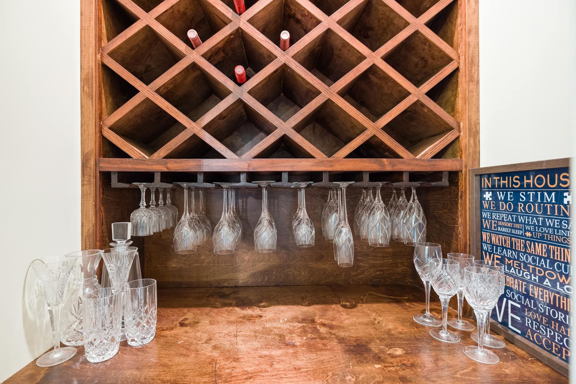 A small curated wine collection on a home shelf with a mix of reds and whites